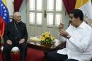 President Nicolas Maduro (R) talks with Monsignor Diego Padron during a meeting in Caracas, Venezuela, on June 14, 2013