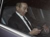 Former CEO of American International Group Inc, Greenberg, checks his phone inside a car after leaving a building in Downtown New York where he was deposed by the Attorney General's office