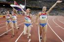 FILE - In this Friday, Aug. 22, 2008, file photo, Russia's Yuliya Chermoshanskaya, right, Yulia Gushchina, second left, Evgeniya Polyakova, left, and Aleksandra Fedoriva, second right, celebrate winning the gold in the women's 4x100-meter relay final at the Beijing 2008 Olympics in Beijing. Russia was stripped of a relay gold medal from the 2008 Beijing Olympics on Tuesday, Aug. 16, 2016, after Chermoshanskaya tested positive for steroids in a reanalysis of her doping samples. (AP Photo/Thomas Kienzle, File)