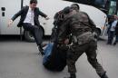 Yusuf Yerkel kicks a protester already held by police