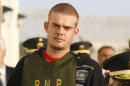 FILE - In this June 4, 2010, file photo, Dutch citizen Joran van der Sloot is escorted by police officers outside a Peruvian police station, near the border with Chile in Tacna, Peru. A Dutch newspaper said on Monday, Oct. 8, 2012, that Joran van der Sloot, who is serving a 28-year-sentence for murdering a young Peruvian woman, has impregnated a woman while imprisoned in Lima. (AP Photo/Karel Navarro, File)