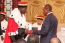 Alpha Conde (R) takes the oath of office for his second five-year term as president of Guinea at the Sekoutoureya royal palace in Conakry on December 21, 2015