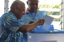 Fiji's military ruler Voreqe Bainimarama, left, casts his vote in a national election in Suva, Fiji, Wednesday, Sept. 17, 2014. Thousands of Fijians got their first chance to vote in eight years in an election that promises to finally restore democracy to the South Pacific nation of 900,000. (AP Photo/Pita Ligaiula)