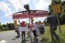 Protesters against drone strikes walk along the highway with a model of a drone in an attempt to deliver a letter to CIA's Brennan as they gather outside CIA headquarters in Langley, Virginia