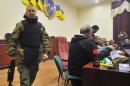 Leaders of pro-Russian activists arrive for a press conference inside the secret services building in the eastern Ukrainian city of Lugansk on April 11, 2014