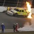 Emergency personnel walk with Juan Pablo Montoya, of Colombia, to an ambulance after his car struck a jet dryer during a caution period in the NASCAR Daytona 500 auto race at Daytona International Speedway in Daytona Beach, Fla., Monday, Feb. 27, 2012. The fuel in the dryer began burning. (AP Photo/Rob Sweeten)