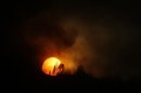 The sun sets over the Beaver Creek wildfire outside Hailey