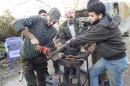 Free Syrian Army fighters prepare homemade rockets in Latakia countryside