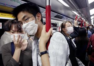 People wear masks to protect against the SARS virus, …