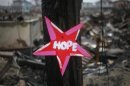 A wooden star is left in front of a burnt house in Breezy Point, almost a month after the neighborhood was left devastated by Hurricane Sandy, in the New York borough of Queens