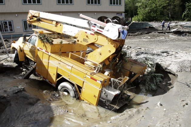 A truck lies in a hole created by the raging waters created by Tropical Storm Irene on Monday, Aug. 29, 2011 in Berlin, Vt. (AP Photo/Toby Talbot)