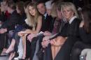 British model Suki Waterhouse, centre left, and her boyfriend U.S actor Bradley Cooper, centre right, watch the show by Tom Ford during London Fashion Week Autumn/Winter 2014, at Lindley Hall in central London, Monday, Feb. 17, 2014. (Photo by Joel Ryan/Invision/AP)