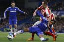 Chelsea's Juan Cuadrado, front, reaches for the ball with Stoke's Charlie Adam during the English Premier League soccer match between Chelsea and Stoke City at Stamford Bridge stadium in London, Saturday, April 4, 2015. (AP Photo/Kirsty Wigglesworth)