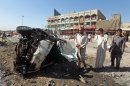 Iraqis inspect the site of a car bomb explosion in Baghdad's impoverished district of Sadr City, on July 29, 2013