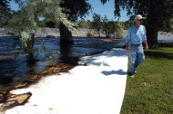 Jim Swanson is seen in his yard east of Laurel, Mont. where absorbent sheets were laid down to soak up oil from a ruptured ExxonMobil pipeline beneath the Yellowstone River Saturday July 2, 2011. (AP Photo/Matthew Brown)