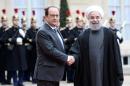 French President Francois Hollande (L) shakes hands with Iranian President Hassan Rouhani upon his arrival on January 28, 2016 at the Elysee Presidential Palace in Paris