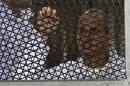 Australian journalist Peter Greste of Al-Jazeera standing inside the defendants cage during his trial at Cairo's Tora prison in Egypt, on March 5, 2014