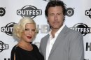 FILE - In this July 7, 2011 file photo, actress Tori Spelling, left, and actor Dean McDermott arrive at the premiere of the feature film 