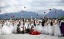Chinese bridal couples toss their flowers after their symbolic wedding in Fuessen
