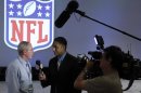 New York Giants coach Tom Coughlin, left, gives an interview at the NFL owners meeting in Palm Beach, Fla., Wednesday, March 28, 2012. (AP Photo/Luis M. Alvarez)