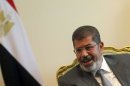 Egypt's president Mohamed Mursi attends a meeting with Hamas leader Khaled Meshaal at the presidential palace in Cairo