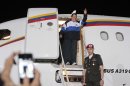 In this photo provided by Miraflores Presidential Press Office, Venezuela's President Hugo Chavez waves from his plane upon arrival to the airport in Barinas, Venezuela, Wednesday April 4, 2012. Chavez returned to Venezuela on Wednesday night after his latest round of radiation therapy treatment in Cuba. (AP Photo/Miraflores Presidential Office)