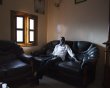 Faye sits on a couch in his house in the village of Ndande