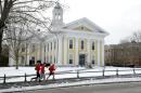 In this Thursday, Jan. 14, 2016 photo, runners make their way along a sidewalk on the campus of Wheaton College, in Norton, Mass. More than 1,000 miles away there's another Wheaton College, in Wheaton, Ill. Though people often confuse the schools, the two aren't related. (AP Photo/Steven Senne)
