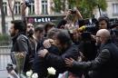 A US university said student Nohemi Gonzalez was among the victims in attacks that claimed at least 129 lives November 13 in Paris, where people gathered November 14 near the Bataclan theatre, scene of some of the worst violence