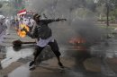 Indonesian Muslim protester throws a Molotov cocktail towards the police during a protest in Jakarta