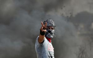 A Palestinian protester flashes the sign for victory &hellip;