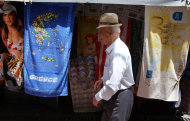 <p> An elderly man walks past a kiosk selling towels printed with high-denomination euro banknotes and the map of Greece in central Athens, Wednesday, May 29, 2013. Greece's central bank says the economy is likely to contract by a further 4.6 percent in 2013 with unemployment set to reach 28 percent. The Bank of Greece's estimate, issued in a report published Wednesday, is worse than the 4.2 percent contraction predicted by the government and the country's rescue lenders. (AP Photo/Thanassis Stavrakis)