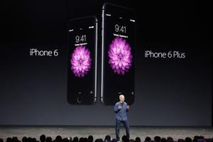 Apple CEO Tim Cook introduces the new iPhone 6 and iPhone 6 Plus during an Apple event at the Flint Center in Cupertino