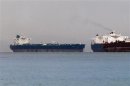 Vessels sail past Malta-flagged Iranian crude oil supertanker "Delvar" anchoring off Singapore