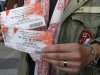 Rolling Stones fan who named himself as Patrice, 55, and who claims he has seen 54 Rolling Stones concerts, shows the tickets he bought for tonight's concert in Paris, Thursday, Oct. 25, 2012. The Rolling Stones announced a surprise "warm-up gig" in Paris, and within an hour the Champs Elysees was swarming with fans hoping to get satisfaction with one of the 350 tickets for the Thursday night show. (AP Photo/Francois Mori)