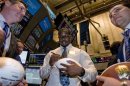 NFL draft prospect Von Miller signs a football for traders on the New York Stock Exchange floor