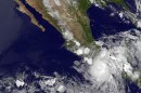 This image provided by NASA acquired Friday at 11 p.m. EDT shows Hurricane Carlotta slammed into Mexico's resort-studded Pacific coast late Friday, toppling trees and lashing hotels while authorities evacuated people from low-lying areas. The rapidly changing hurricane made landfall as a Category 1 storm near Puerto Escondido, a laid-back port popular with surfers, and is expected to push inland and northward in the direction of Acapulco. (AP Photo/NASA)