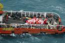 The tail of AirAsia QZ8501 passenger plane is seen on the deck of the rescue ship Crest Onyx after it was lifted from the sea bed, south of Pangkalan Bun, Central Kalimantan