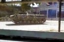 This image made from amateur video released by the Shaam News Network and accessed Thursday, April 12, 2012, purports to show a Syrian military armored vehicle in Idlib, Syria. Syrian forces halted attacks on opposition strongholds Thursday in line with a U.N.-brokered truce but the regime defied demands by international envoy Kofi Annan to pull troops back to their barracks, activists said. (AP Photo/Shaam News Network via AP video) TV OUT, THE ASSOCIATED PRESS CANNOT INDEPENDENTLY VERIFY THE CONTENT, DATE, LOCATION OR AUTHENTICITY OF THIS MATERIAL