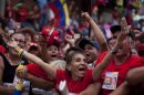 Supporters of Venezuela's President Hugo Chavez cheer during a campaign rally in Maracay, Venezuela, Wednesday, Oct. 3, 2012. Chavez is running for re-election against opposition candidate Henrique Capriles in presidential elections on Oct . 7. (AP Photo/Rodrigo Abd)