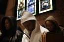 Congregants bow their heads in prayer during a service at Middle Collegiate Church in New York, Sunday, March 25, 2012. Church-goers were invited to wear hoodies to services to show their support for justice in the case of Trayvon Martin, an unarmed black teenager who was wearing a hoodie on the night he was killed by a neighborhood watch captain in Florida. (AP Photo/Seth Wenig)