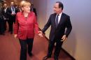 German Chancellor Angela Merkel (L) is greeted by French President Francois Hollande prior to their bilateral meeting on the sidelines of a EU summit on October 24, 2013