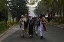 Afghan delegates walk through the grounds of the loya jirga in Kabul on November 22, 2013