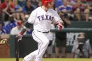 Rangers Hamilton follows though on a two-run triple against Athletics pitcher Milone in the first inning of their MLB American League baseball game in Arlington, Texas