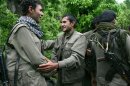 Kurdish fighters from the Kurdistan Workers Party (PKK) congratulate each other after arriving in the Heror area, northeast of Dahuk, 260 miles (430 kilometers) northwest of Baghdad, Iraq, Tuesday, May 14, 2013. The first of Kurdish fighters from Turkey have entered northern Iraq as part of a peace deal to end a long uprising, despite Iraqi objections to the transfer. Comrades greeted 13 armed men and women from the Kurdistan Workers Party (PKK) at a ceremony in Heror in Iraq's self-ruled Kurdish area. The central government in Baghdad has rejected the deal, warning that the entry of more armed Kurdish fighters could harm the country's security. (AP Photo/ Ceerwan Aziz)