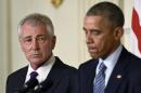 Defense Secretary Chuck Hagel, left, listens as President Barack Obama, right, talks about Hagel's resignation during an event in the State Dining Room of the White House in Washington, Monday, Nov. 24, 2014. Hagel is stepping down under pressure from Obama's Cabinet, senior administration officials said Monday, following a tenure in which he has struggled to break through the White House's insular foreign policy team. (AP Photo/Susan Walsh)