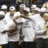 Virginia Commonwealth basketball players congratulate MVP Darius Theus , center, as they celebrate winning the Colonial Athletic Association Championship NCAA college basketball game at the Coliseum  in Richmond, Va., Monday, March 5, 2012.   VCU  won the game 59-56. (AP Photo/Steve Helber)