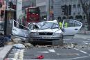 A smashed up car is seen in Kingsway opposite Holborn Tube station in central London, after a woman was killed when large chunks of masonry fell onto a Skoda Octavia vehicle she was in, London, Saturday, Feb. 15, 2014. The taxi driver was killed late Friday in central London opposite Holborn subway station during a heavy windstorm when her car was crushed by falling masonry from a building that partially collapsed, police said. She was identified as Julie Sillitoe, a 49-year-old with three sons. (AP Photo/PA, Laura Lean) UNITED KINGDOM OUT