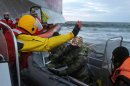 An officer of Russian Coast Guard points a knife at a Greenpeace activist in the Pechora Sea on September 18, 2013