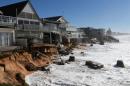 High tide begins to impact on beachfront homes already damaged by a weekend storm along the Pacific Ocean at Collaroy on the northern beaches of Sydney